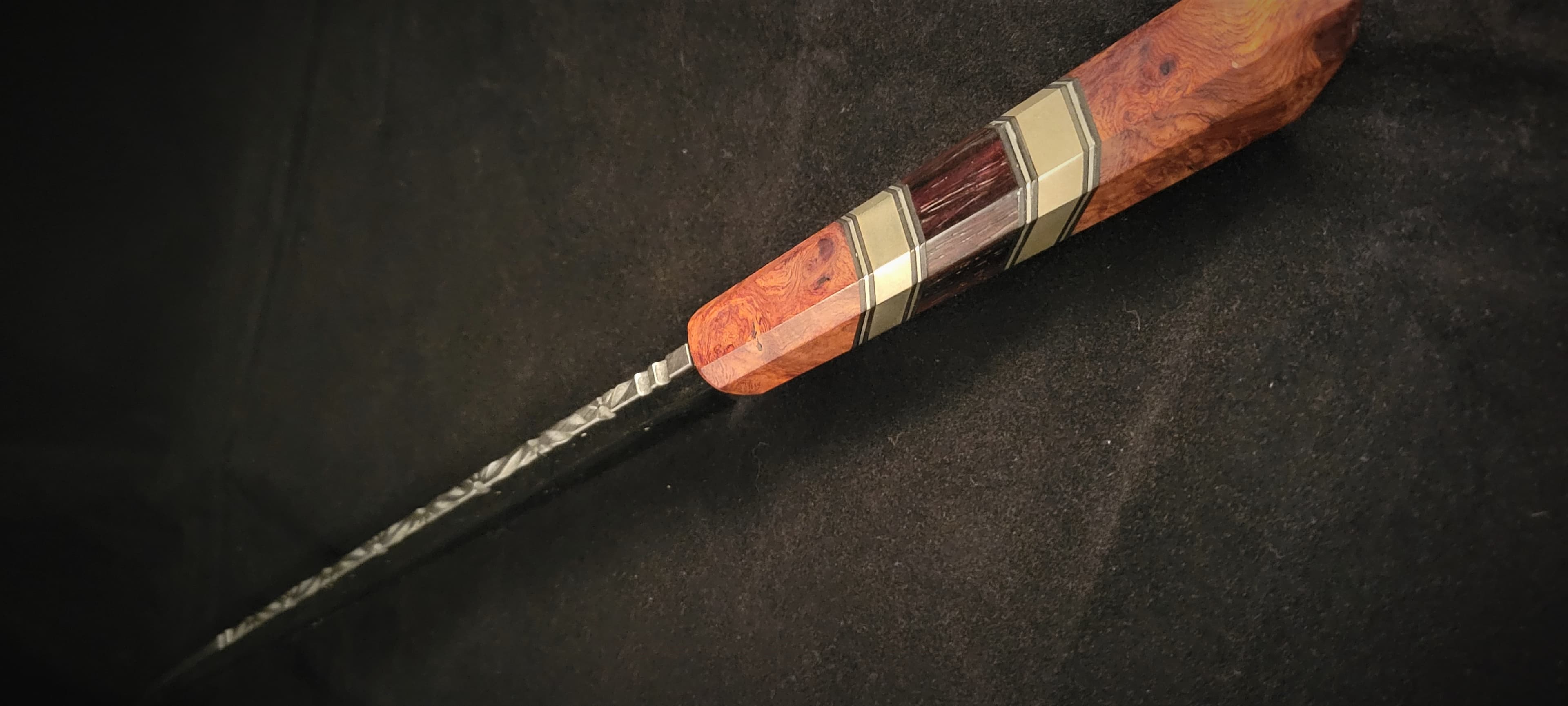 Custom hand-forged knife with twisted handle and brass accents