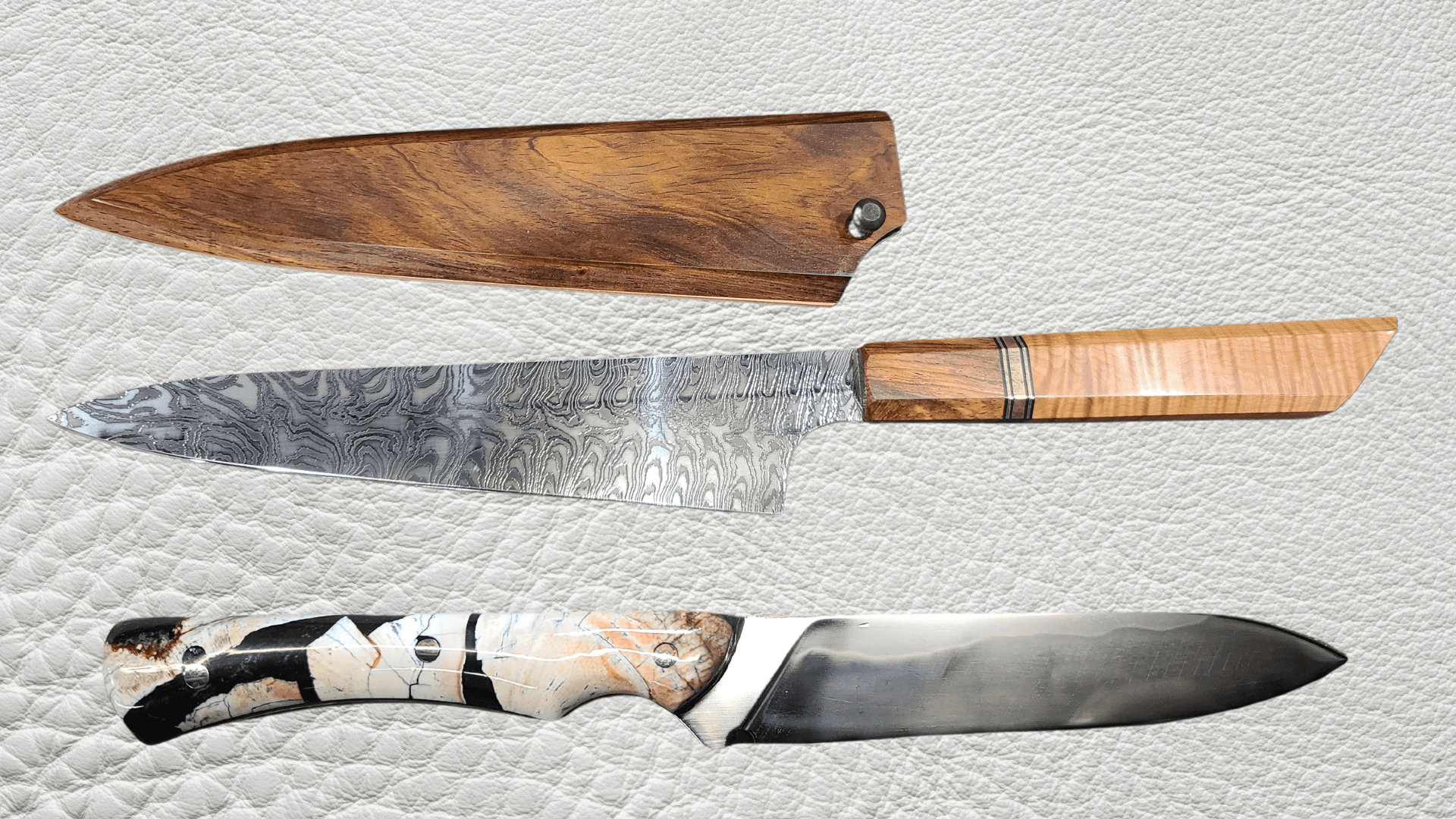 Collection of custom handmade knives with unique handle materials